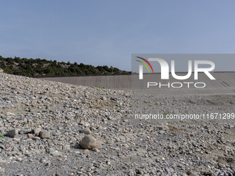 Visible banks, dry soil, and uncultivated vegetation replace the water at Lake Monte Cotugno, a reservoir in Basilicata, which in the summer...