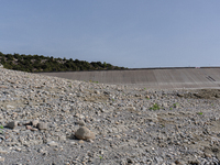 Visible banks, dry soil, and uncultivated vegetation replace the water at Lake Monte Cotugno, a reservoir in Basilicata, which in the summer...