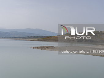 Visible banks, dry soil, and uncultivated vegetation replace the water at Lake Monte Cotugno, a reservoir in Basilicata, which in the summer...