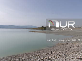 Visible banks, dry soil, and uncultivated vegetation replace the water at Lake Monte Cotugno, a reservoir in Basilicata, which in the summer...