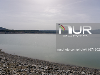 Visible banks, dry soil, and uncultivated vegetation replace the water at Lake Monte Cotugno, a reservoir in Basilicata, which in the summer...