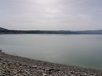 Visible banks, dry soil, and uncultivated vegetation replace the water at Lake Monte Cotugno, a reservoir in Basilicata, which in the summer...