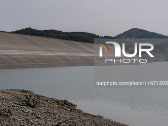 Visible banks, dry soil, and uncultivated vegetation replace the water at Lake Monte Cotugno, a reservoir in Basilicata, which in the summer...