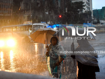 Women hold umbrellas as they walk on the street during heavy rain in Kolkata, India, on October 16, 2024. (