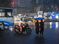 Women hold umbrellas as they walk on the street during heavy rain in Kolkata, India, on October 16, 2024. (