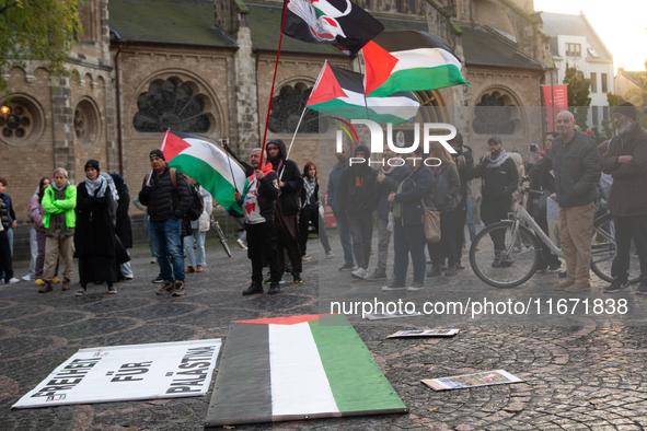 Dozens of pro-Palestinian activists gather at Muenster Square and protest against Israeli airstrike in Bonn, Germany, on October 16, 2024. 