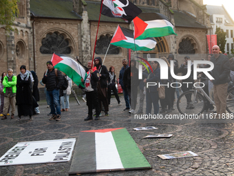 Dozens of pro-Palestinian activists gather at Muenster Square and protest against Israeli airstrike in Bonn, Germany, on October 16, 2024. (