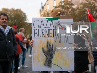 Dozens of pro-Palestinian activists gather at Muenster Square and protest against Israeli airstrike in Bonn, Germany, on October 16, 2024. (