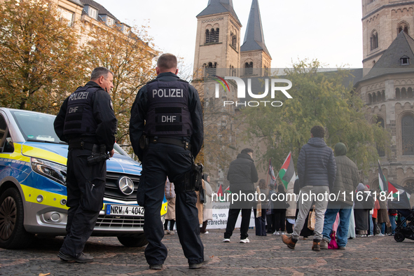 Police observe the demonstration site as dozens of pro-Palestinian activists gather at Muenster Square and protest against deadly Israeli ai...