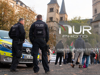 Police observe the demonstration site as dozens of pro-Palestinian activists gather at Muenster Square and protest against deadly Israeli ai...