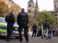 Police observe the demonstration site as dozens of pro-Palestinian activists gather at Muenster Square and protest against deadly Israeli ai...