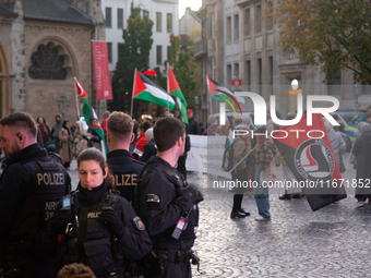 Police observe the demonstration site as dozens of pro-Palestinian activists gather at Muenster Square and protest against deadly Israeli ai...