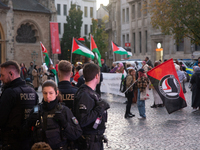 Police observe the demonstration site as dozens of pro-Palestinian activists gather at Muenster Square and protest against deadly Israeli ai...