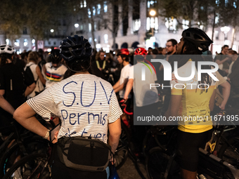 A cyclist wears a T-shirt that reads ''SUV licence to kill'' during a gathering to pay tribute to Paul, 27, a cyclist who was run over two d...