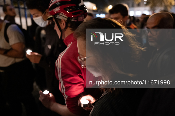 This photograph shows bunches of mainly white flowers displayed with candles as cyclists pay tribute to Paul, 27, a cyclist who was run over...