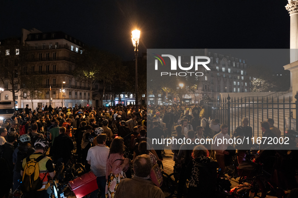 People gather to pay tribute to Paul, 27, a cyclist who is run over by a car in Paris following a dispute, at Place de la Madeleine with the...