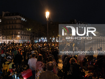 People gather to pay tribute to Paul, 27, a cyclist who is run over by a car in Paris following a dispute, at Place de la Madeleine with the...