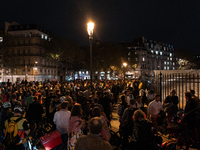 People gather to pay tribute to Paul, 27, a cyclist who is run over by a car in Paris following a dispute, at Place de la Madeleine with the...