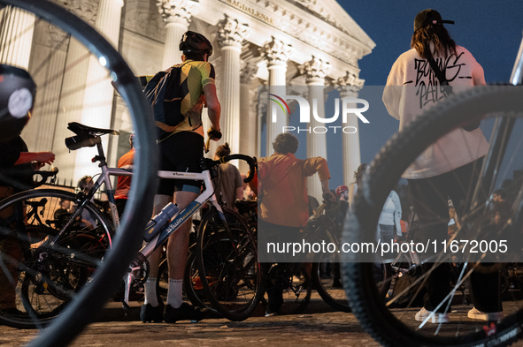 People gather to pay tribute to Paul, 27, a cyclist who is run over by a car in Paris following a dispute, at Place de la Madeleine with the...