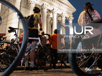 People gather to pay tribute to Paul, 27, a cyclist who is run over by a car in Paris following a dispute, at Place de la Madeleine with the...