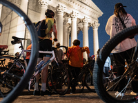 People gather to pay tribute to Paul, 27, a cyclist who is run over by a car in Paris following a dispute, at Place de la Madeleine with the...