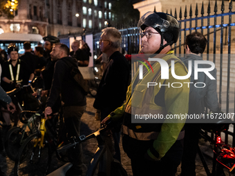 People gather to pay tribute to Paul, 27, a cyclist who is run over by a car in Paris following a dispute, at Place de la Madeleine with the...