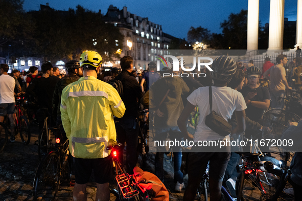 People gather to pay tribute to Paul, 27, a cyclist who is run over by a car in Paris following a dispute, at Place de la Madeleine with the...