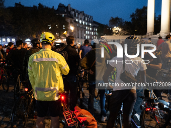 People gather to pay tribute to Paul, 27, a cyclist who is run over by a car in Paris following a dispute, at Place de la Madeleine with the...