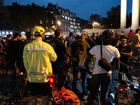 People gather to pay tribute to Paul, 27, a cyclist who is run over by a car in Paris following a dispute, at Place de la Madeleine with the...