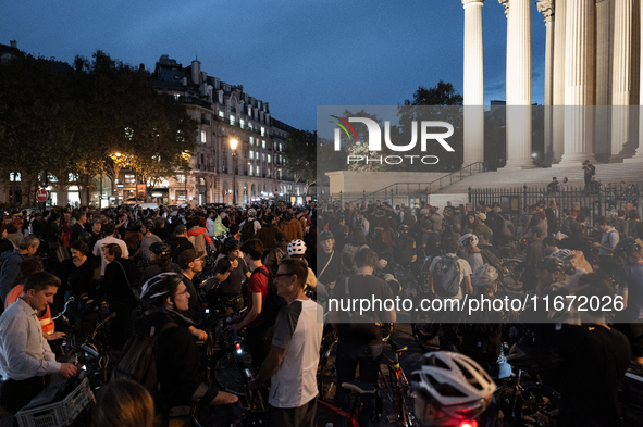 People gather to pay tribute to Paul, 27, a cyclist who is run over by a car in Paris following a dispute, at Place de la Madeleine with the...