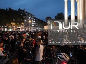 People gather to pay tribute to Paul, 27, a cyclist who is run over by a car in Paris following a dispute, at Place de la Madeleine with the...