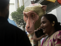 Indian members of 'People for the Ethical Treatment of Animals' (PETA) protest with a giant statue of a wounded and tormented 'monkey' and h...