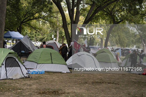 In Washington, DC, on October 14, an Indian tribe from San Francisco rides on horses and makes it to the National Mall, where they have been...