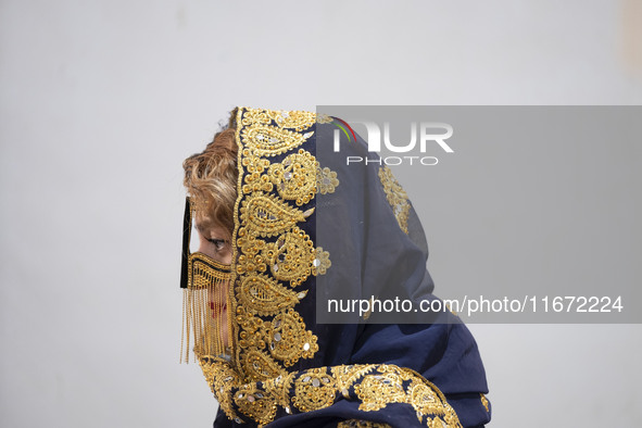 An Iranian woman wears a traditional headscarf and a burqa during the 11th National Handicrafts and 3rd International Tourism Exhibition in...