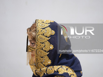 An Iranian woman wears a traditional headscarf and a burqa during the 11th National Handicrafts and 3rd International Tourism Exhibition in...