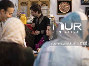 An Iranian female artist sits at her stand during the 11th National Handicrafts and 3rd International Tourism Exhibition in the historical c...