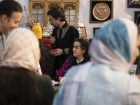 An Iranian female artist sits at her stand during the 11th National Handicrafts and 3rd International Tourism Exhibition in the historical c...