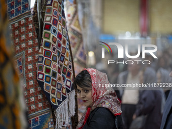 An Iranian woman visits the 11th National Handicrafts and 3rd International Tourism Exhibition in the historical city of Tabriz, located 624...