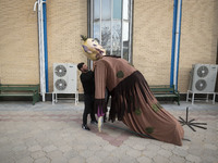 An Iranian man adjusts an effigy during the 11th National Handicrafts and 3rd International Tourism Exhibition in the historical city of Tab...