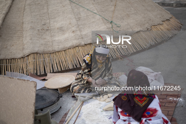 Two Iranian nomadic women work with dough while participating in the 11th National Handicrafts and 3rd International Tourism Exhibition in t...