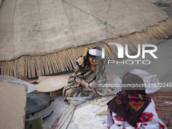 Two Iranian nomadic women work with dough while participating in the 11th National Handicrafts and 3rd International Tourism Exhibition in t...