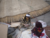 Two Iranian nomadic women work with dough while participating in the 11th National Handicrafts and 3rd International Tourism Exhibition in t...