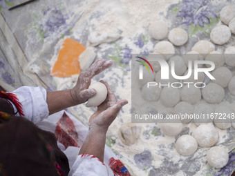 An Iranian nomadic woman works with dough while participating in the 11th National Handicrafts and 3rd International Tourism Exhibition in T...