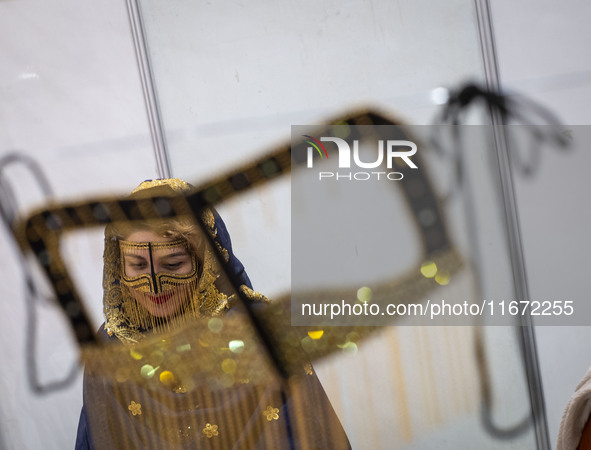 An Iranian woman wears a traditional headscarf and a burqa during the 11th National Handicrafts and 3rd International Tourism Exhibition in...