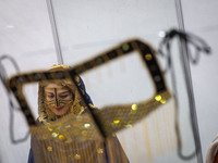 An Iranian woman wears a traditional headscarf and a burqa during the 11th National Handicrafts and 3rd International Tourism Exhibition in...