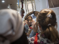 An Iranian woman tries on sunglasses while visiting the 11th National Handicrafts and 3rd International Tourism Exhibition in the historical...