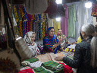 Iranian saleswomen talk to clients during the 11th National Handicrafts and 3rd International Tourism Exhibition in the historical city of T...