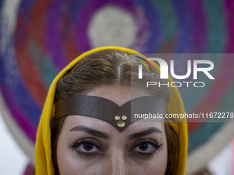 An Iranian female artist poses for a photograph at the 11th National Handicrafts and 3rd International Tourism Exhibition in Tabriz, Iran, o...