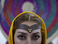 An Iranian female artist poses for a photograph at the 11th National Handicrafts and 3rd International Tourism Exhibition in Tabriz, Iran, o...