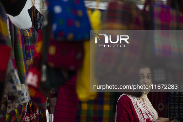 An Iranian saleswoman stands at her stand during the 11th National Handicrafts and 3rd International Tourism Exhibition in Tabriz, Iran, on...